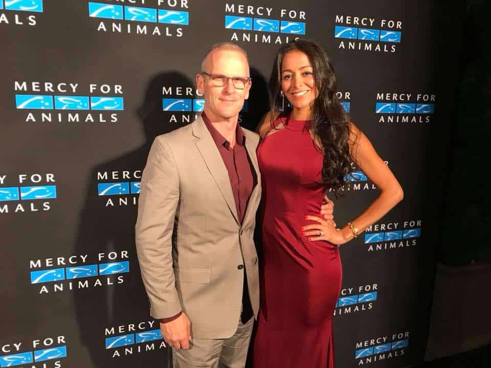 Jim Glackin and fellow attendee stand together for photographs at a Mercy for Animals formal event.