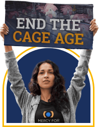 Woman holding sign that says end the cage age