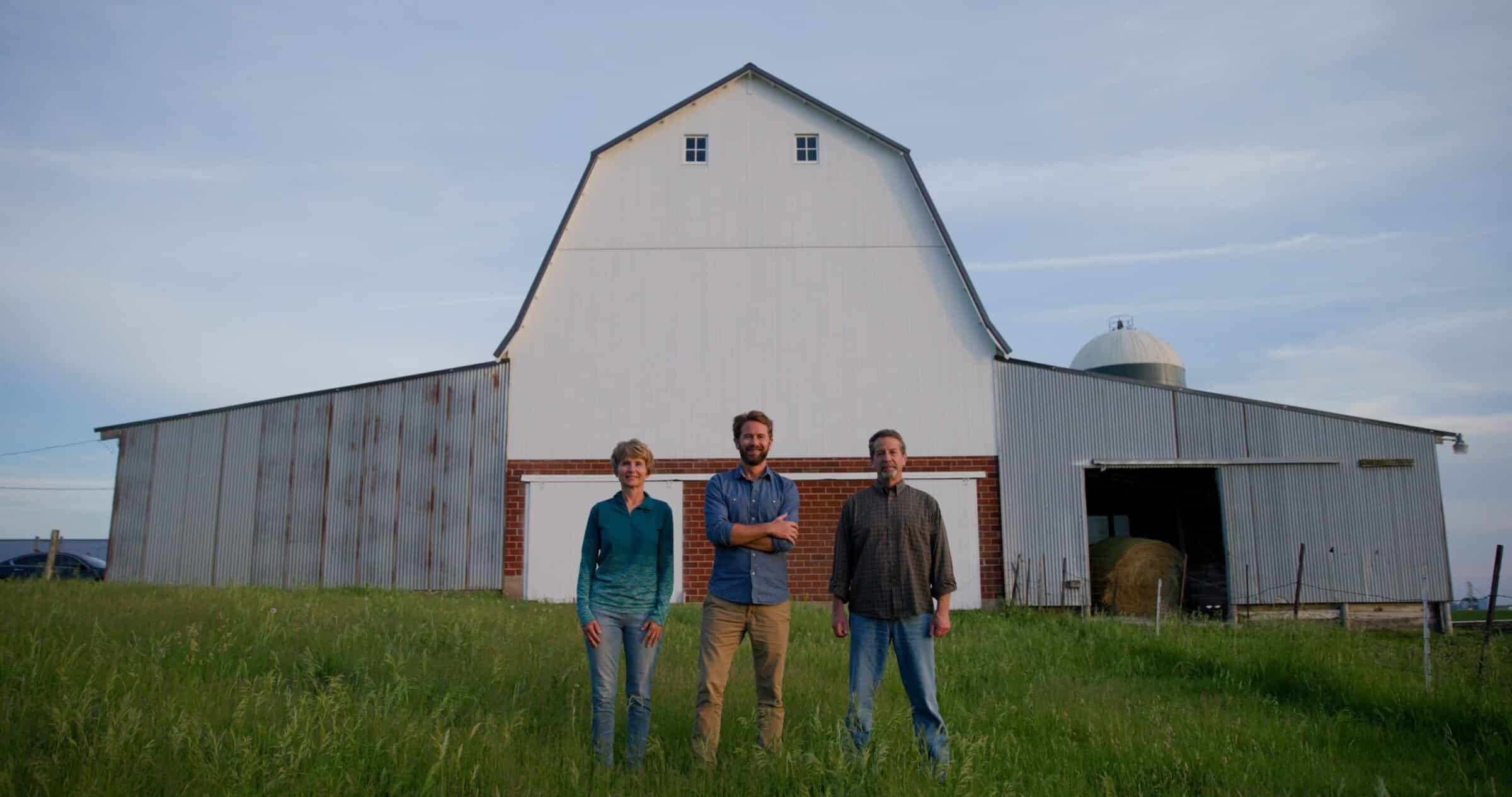 The Faaborg family stands in front of their barn