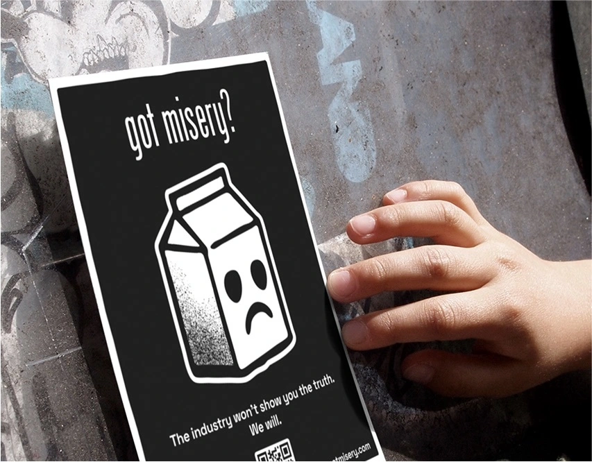 Photograph of a flyer bearing the campaign slogan “got misery?” and an image of a milk carton with a sad face.