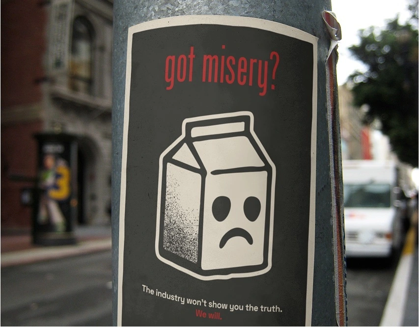 Photograph of a poster bearing the campaign slogan “got misery?” and an image of a milk carton with a sad face.
